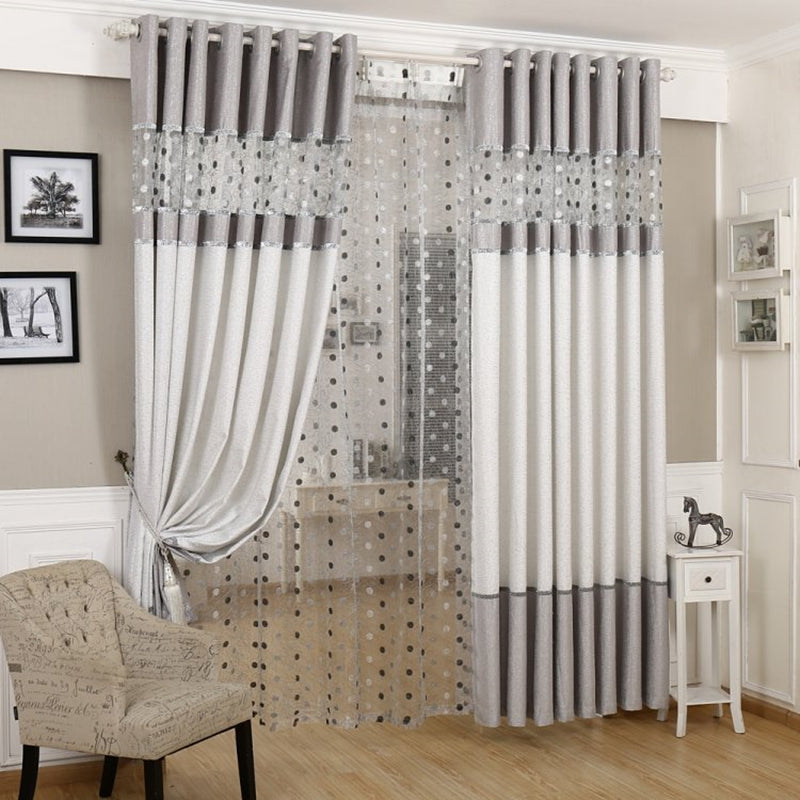 Simple blackout curtains in a solid design, shown hanging over a window