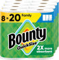 Bounty paper towels Quick Size in white, 16 family rolls, shown in a kitchen setting with towels partially unrolled.