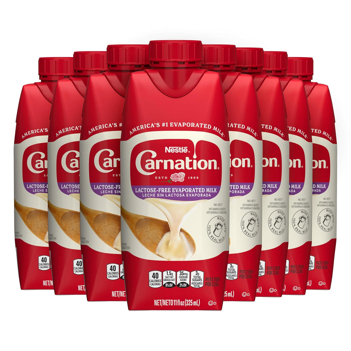 Eight cans of Carnation lactose-free evaporated milk in an 8-pack, showing the product label and packaging.