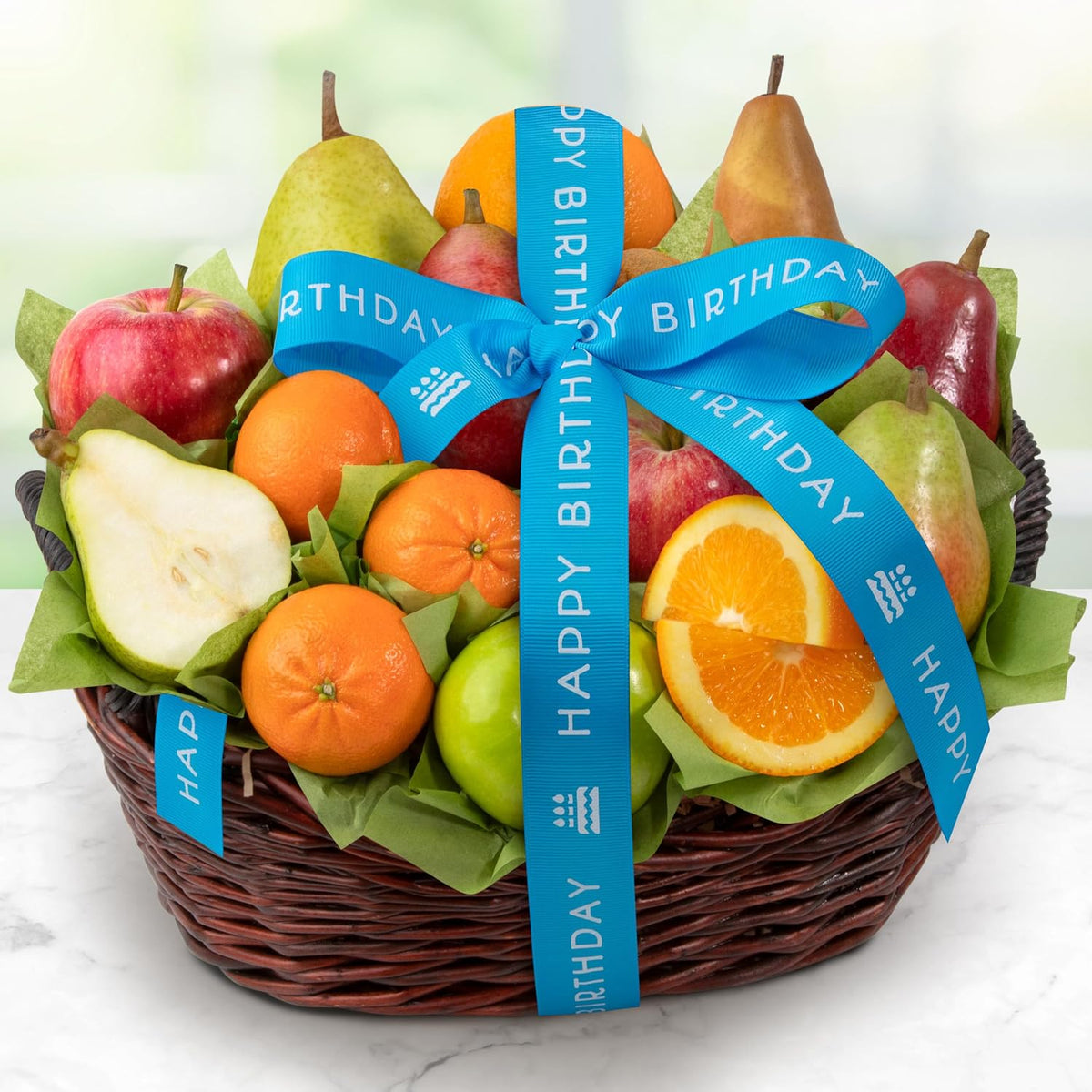 Fresh fruit gift basket by A Gift Inside with pears, apples, kiwi, and navel oranges, decorated with a happy birthday ribbon.