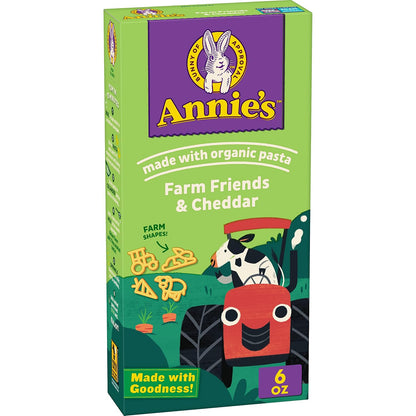 Annie's Shells & White Cheddar organic packaged mac and cheese in a 4-pack, showing creamy cheese sauce and pasta shells