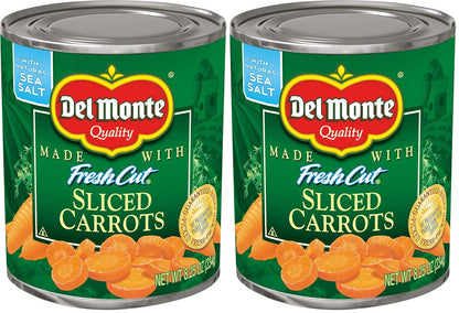 Cans of Del Monte sliced carrots in a pack of 12, showing the prepackaged orange carrots inside the labeled cans.