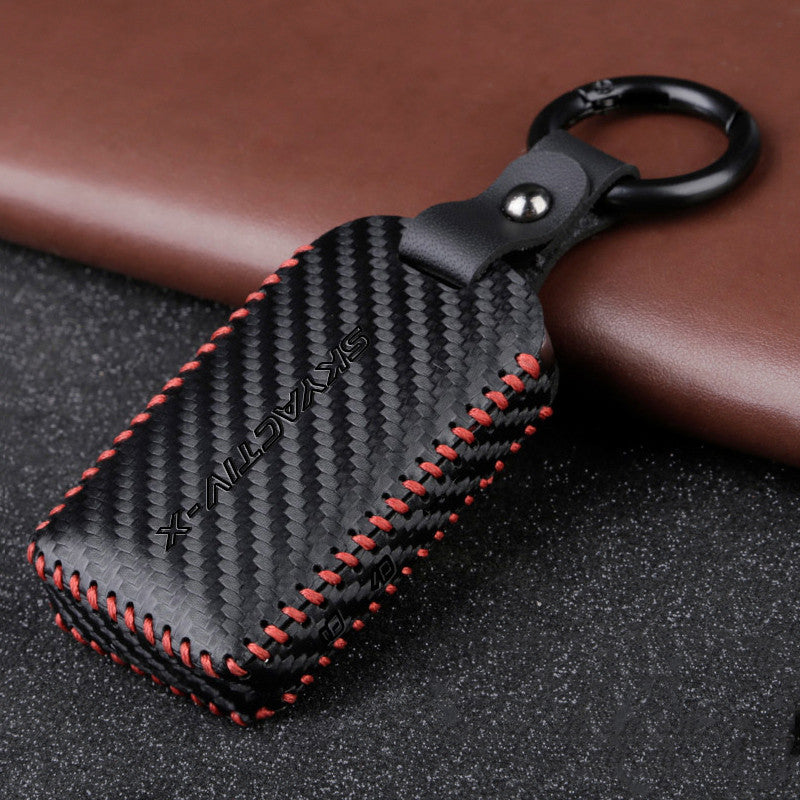 Black leather car key case with button closure and keyring hole