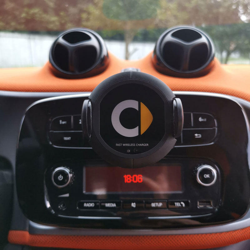 Car wireless charger mounted on a vehicle dashboard, featuring a compact charging cradle for smartphones