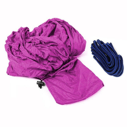 Portable nylon parachute double backpacking hammock for outdoor camping, shown in a compact setup