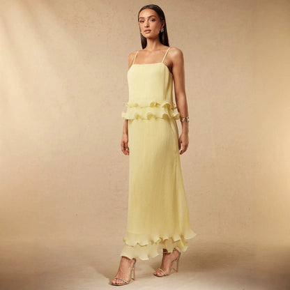 Pleated yellow strap spliced tiered long dress with flowing silhouette and delicate shoulder straps