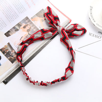 Big bow tie bunny ears headband with playful rabbit ears on a simple accessory band