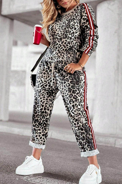 Plus size leopard print round neck top and pants set for women, stylish and comfortable fashion by Trendsi.