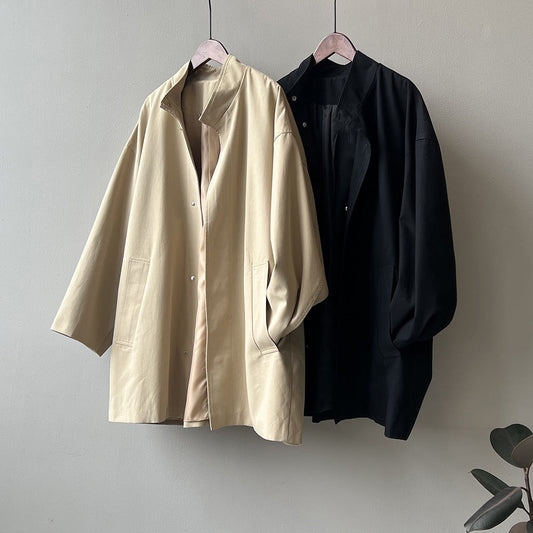 Japanese-style women's stand-collar workwear trench coat in a long, structured silhouette