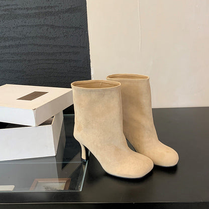 Solid-color commuter-style versatile booties in a low ankle design, side view