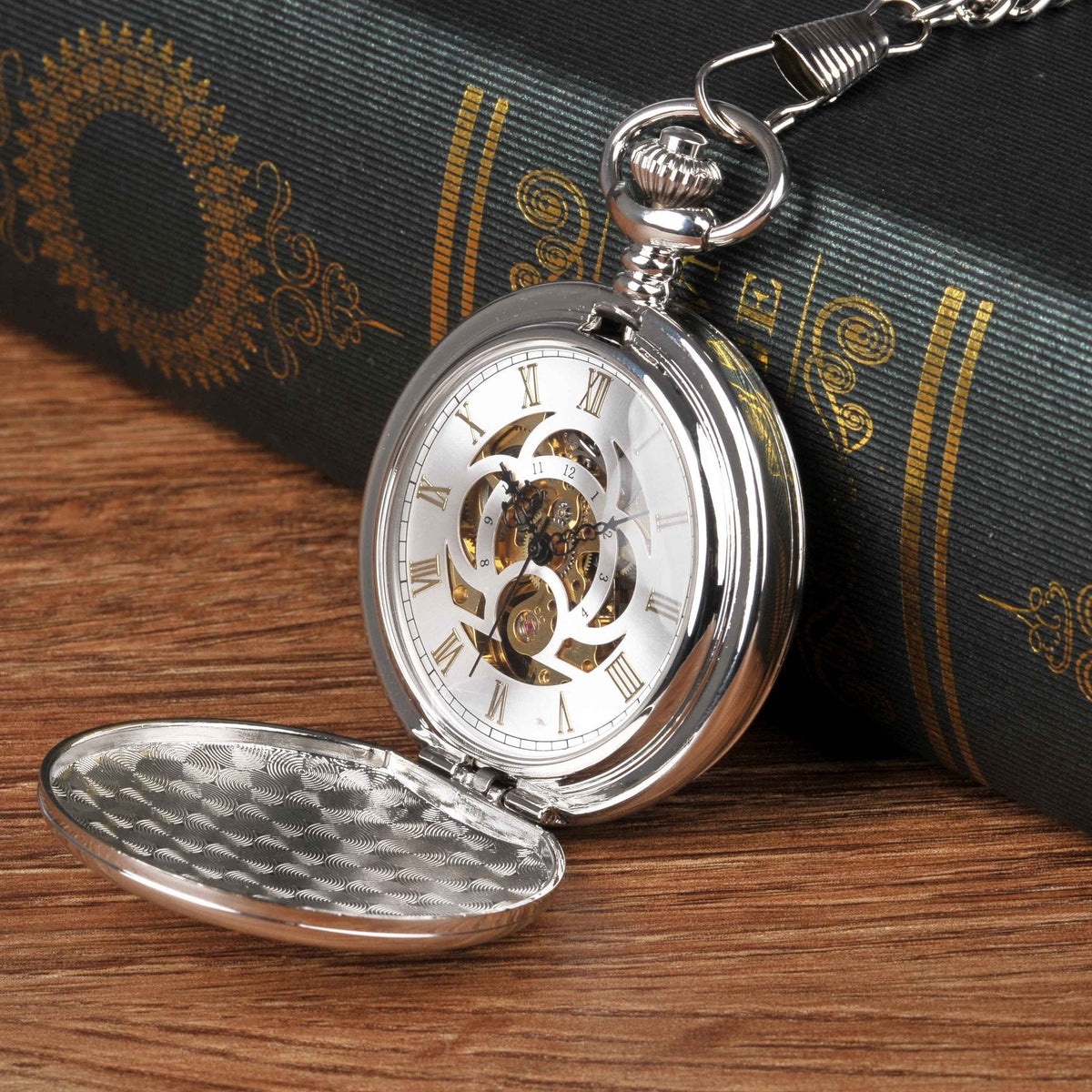 Large silver mechanical pocket watch with double-hinged case and visible pocket watch design