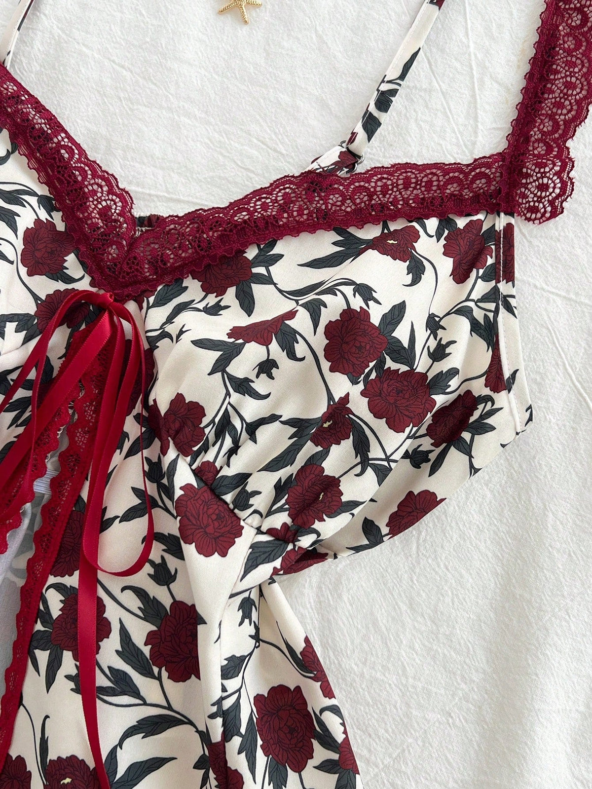 Lace-trimmed camisole with floral bow detail in a fashionable, versatile design