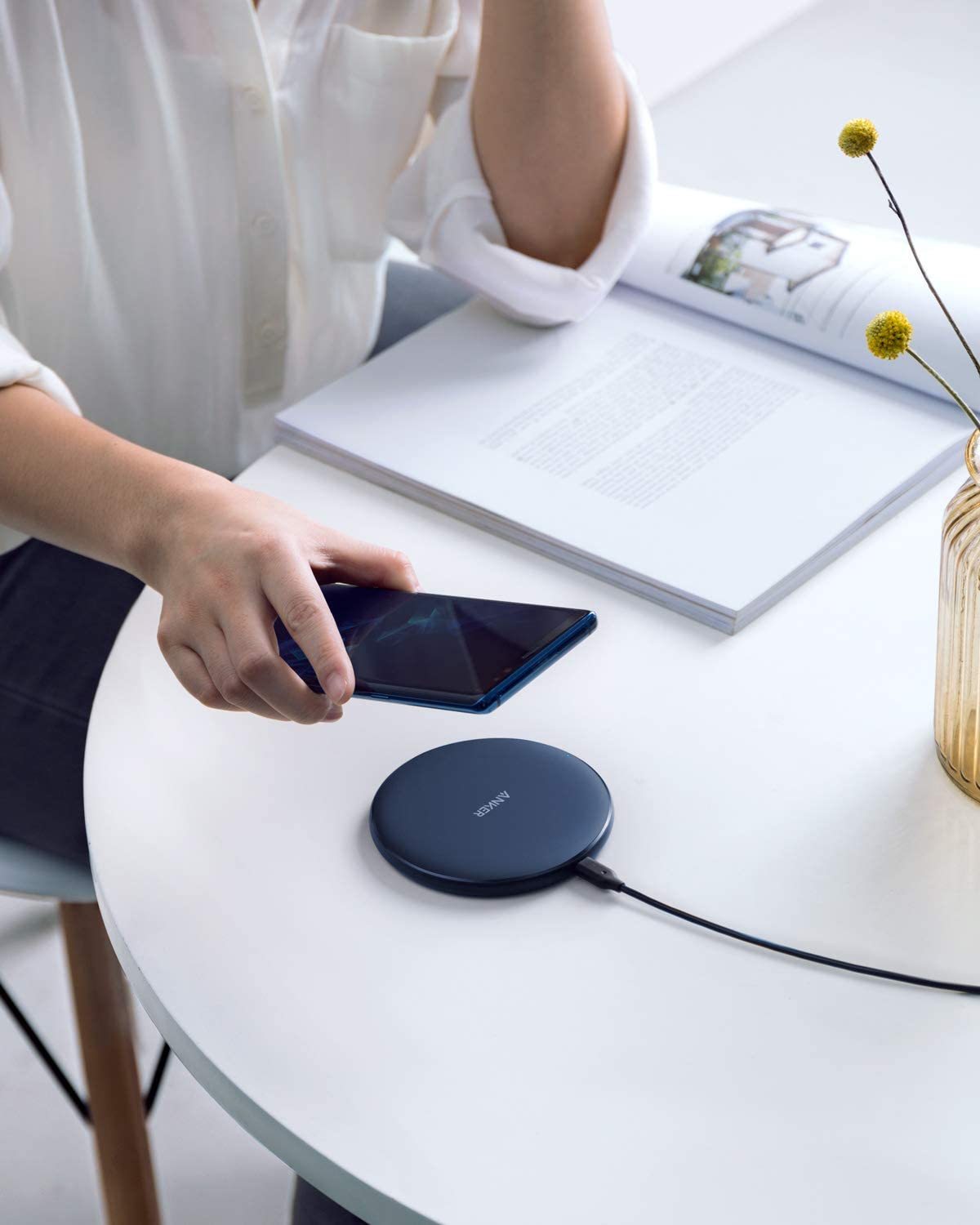 Anker 313 wireless charging pad for charging devices, featuring a sleek flat design and smooth surface for wireless power transfer.