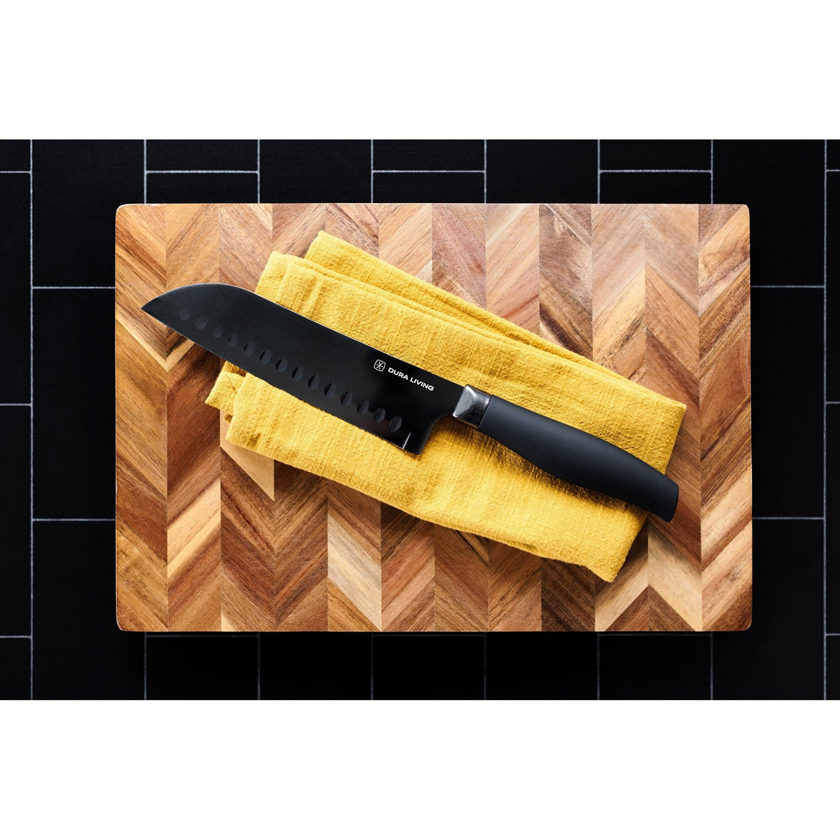 Dura Living Titan 7-inch black Santoku knife with stainless steel blade and ergonomic handle for precise slicing and chopping.