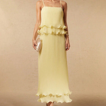 Pleated yellow strap spliced tiered long dress with flowing silhouette and adjustable shoulder straps