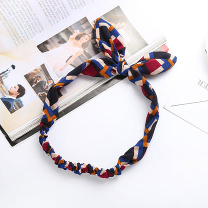 Big bow tie bunny ears headband in a playful design