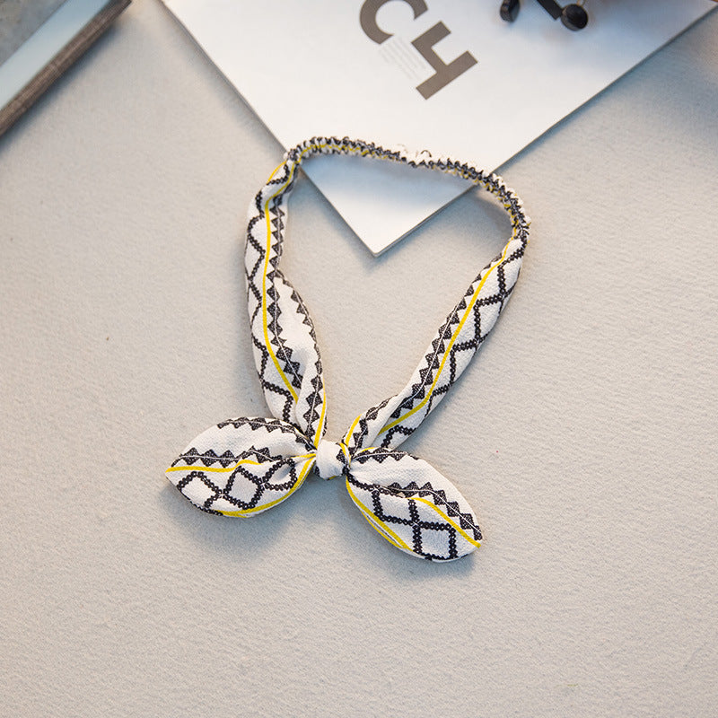 Big bow tie bunny ears headband with oversized bow detail and playful rabbit ears.