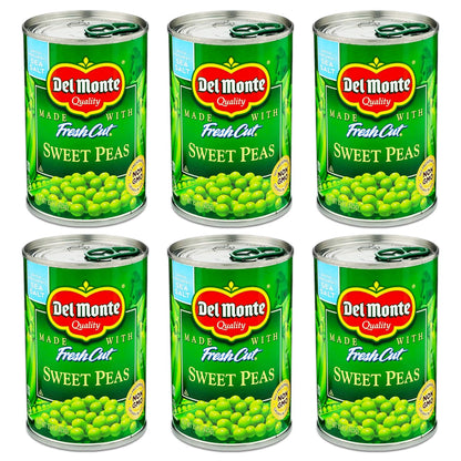 Canned Del Monte sweet peas in 15-ounce cans, fresh cut green peas in a pack of four, showing bright green peas inside each can.
