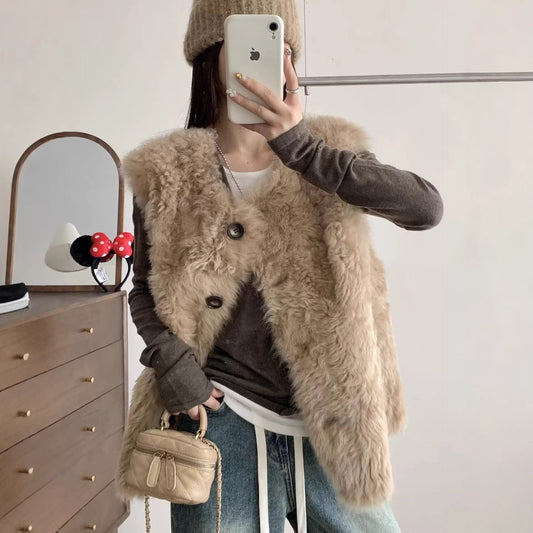 Sheepskin-look mid-length leather-and-fur vest in neutral tones, front view