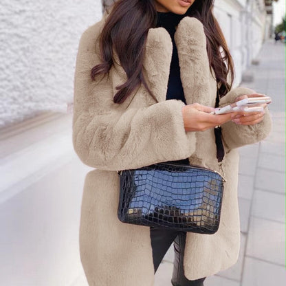 Women's solid color long sleeve lapel faux fur coat with a soft, elegant design