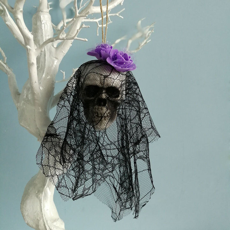 Halloween skull hanging decor suspended by a cord with detailed skull features and spooky design