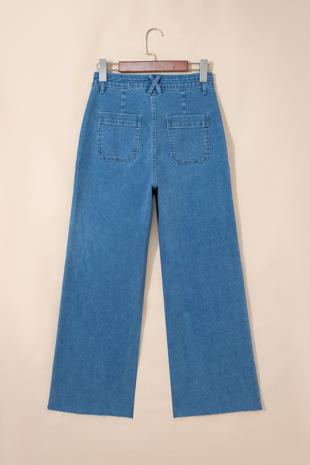 Stretchy Lucie Patch jeans by Threaded Pear featuring patch details and a slim fit, shown in a casual style.