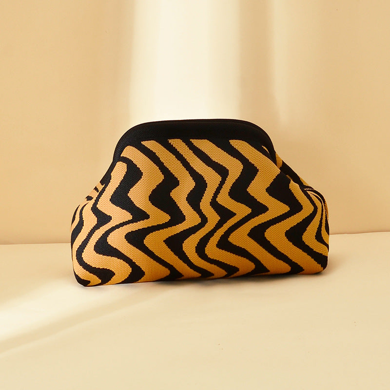Women's knitted striped clutch bag in a compact woven design