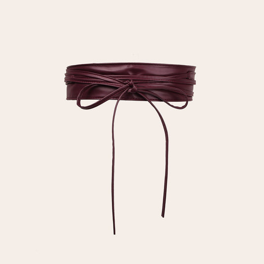 Women's faux leather wide waist cincher belt with lace-up bow detail