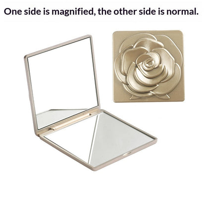 Portable folding mirror with electroplated rose design, shown closed with a pink metallic finish