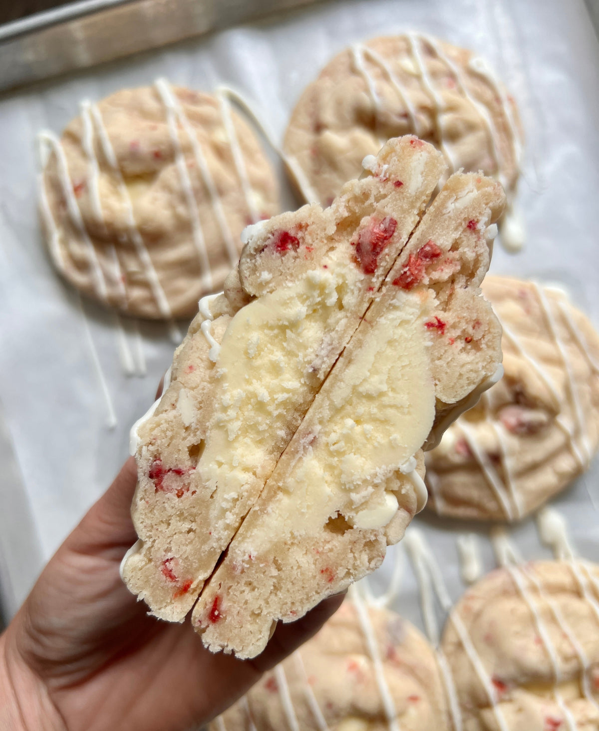 Fresh strawberries topped with creamy whipped cream on a dessert plate, from Let's Get Baked Artisan Desserts.