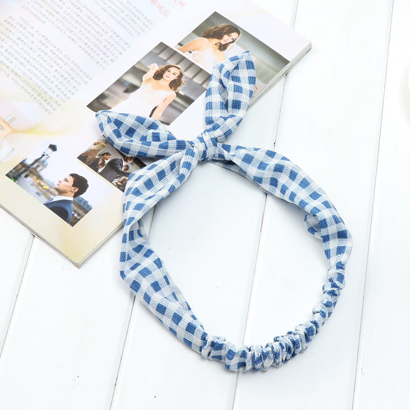 Big bow tie bunny ears headband with oversized bow and soft rabbit ears, close-up view