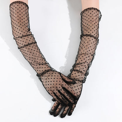 Women's black polka-dot extended lace gloves on a plain background