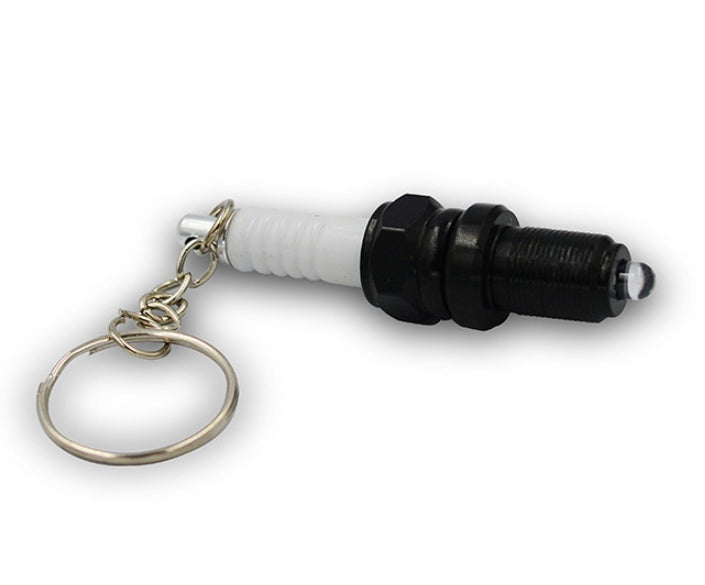 LED light spark plug keychain with compact metallic design and attached key ring