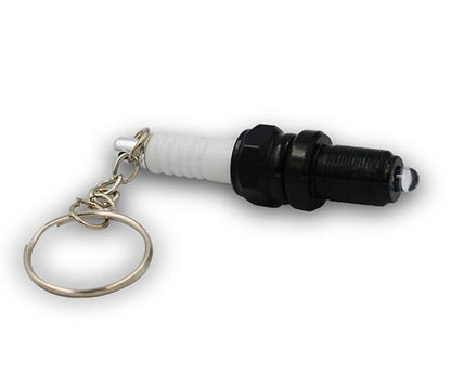 LED light spark plug keychain with compact metallic design and attached key ring