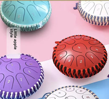 Apple-shell ethereal steel tongue drum, Type 4, with rounded metal shell and tongue-shaped cutouts