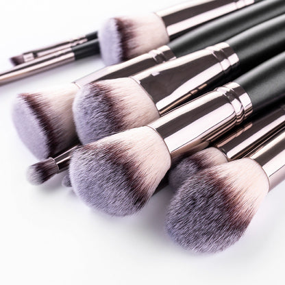 15-piece matte black makeup brush set with assorted cosmetic brushes and makeup tools laid out neatly