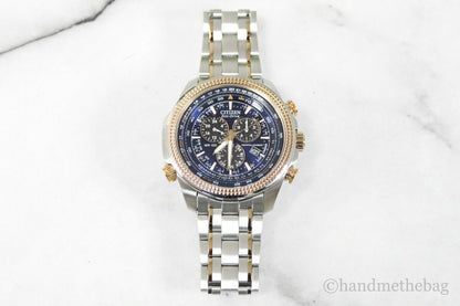 Citizen Eco Drive men's chronograph watch with two-tone stainless steel band and black dial, featuring multiple subdials and silver accents.