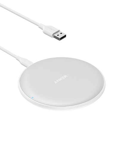 Anker 313 wireless charging pad for charging devices, slim black pad with charging indicator light on smooth surface.