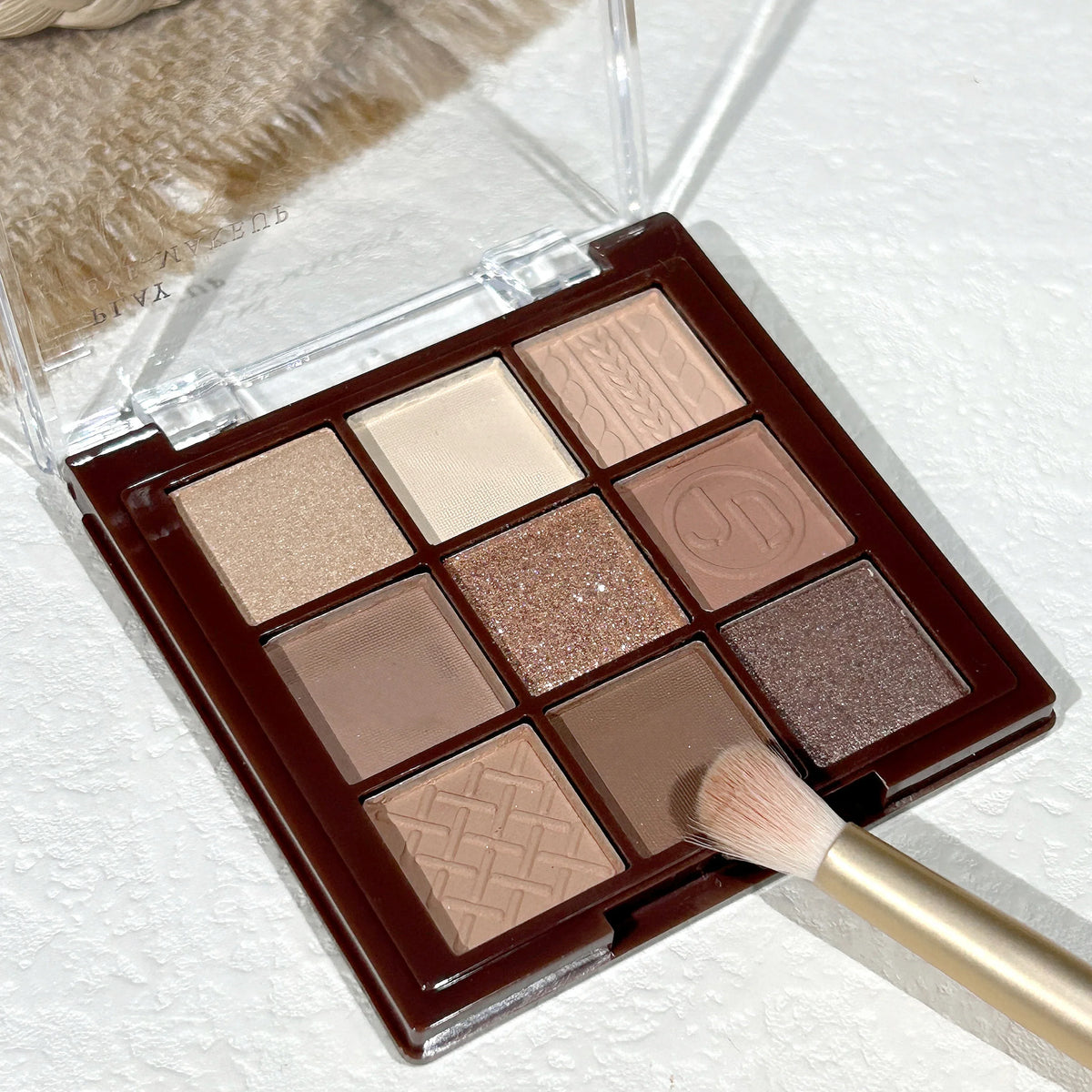 Blushimmer Chocolate Warm Brown Earth Palette with 9 matte, orange, brown, and glitter eyeshadows in a compact palette.