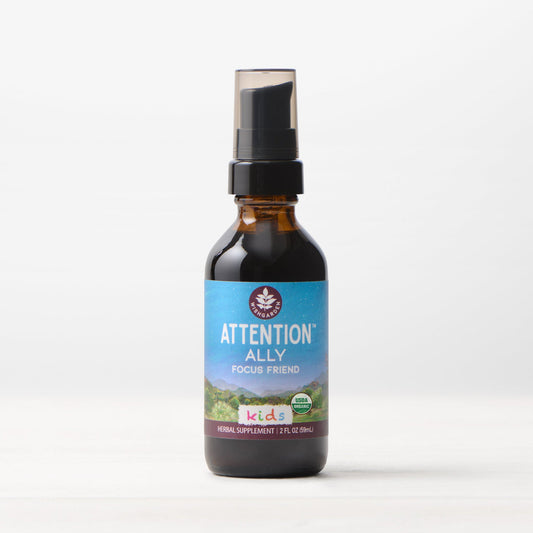 Kids taking Attention Ally, WishGarden Herbs focus supplement, with colorful packaging and natural ingredients in the background.