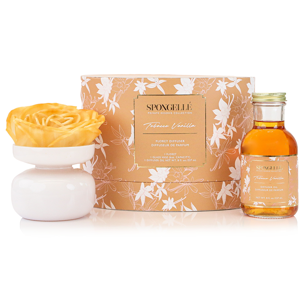 Private Reserve Tobacco Vanilla home fragrance diffuser by Spongellé with a sleek glass bottle and reed sticks for aromatic scent.