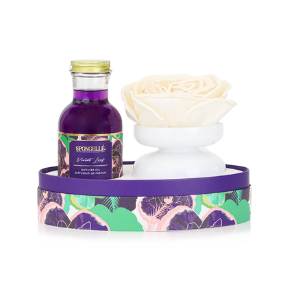Violet Leaf Private Reserve diffuser by Spongellé, a home fragrance with a sleek bottle and reed sticks for elegant scent diffusion.