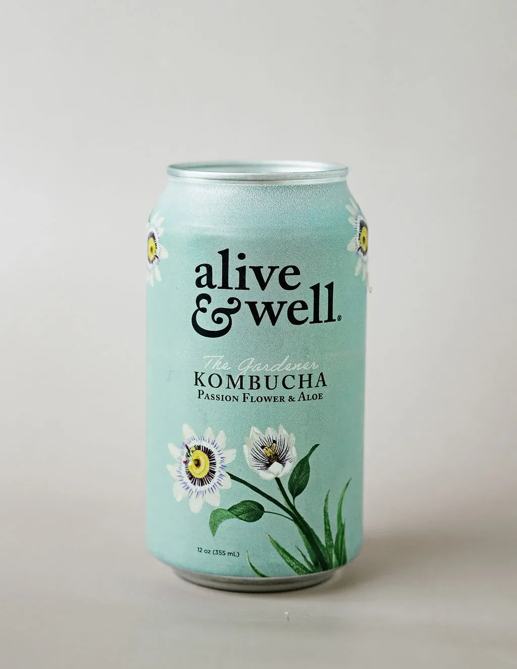 Organic Aloe and Passion Flower Kombucha by Alive & Well in a six-pack, showing colorful bottles with fresh fruit ingredients.