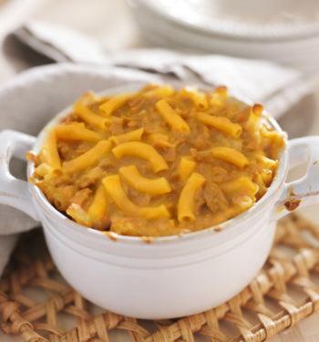 AmBari Nutrition CheeseSteak Pasta meal in a bowl, showing creamy cheese sauce, pasta, and sliced steak pieces.