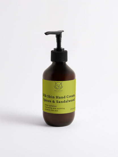 Amber glass pump bottle of BelleVie Silk Skin Hand Cream with lime green label, black pump, against a white background.