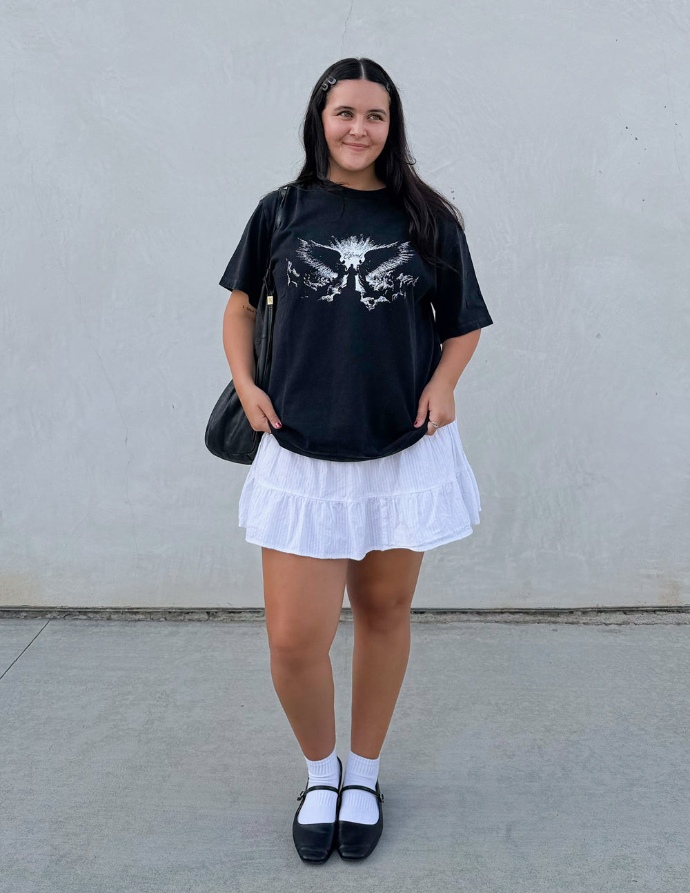 Elevated Faith Angels Heavyweight Tee, a casual black T-shirt featuring a bold angel graphic design on the front.