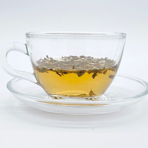Loose leaf Arabica herbal tea from Novel Tea Book Shop, showcasing fresh, dried tea leaves in a natural setting.