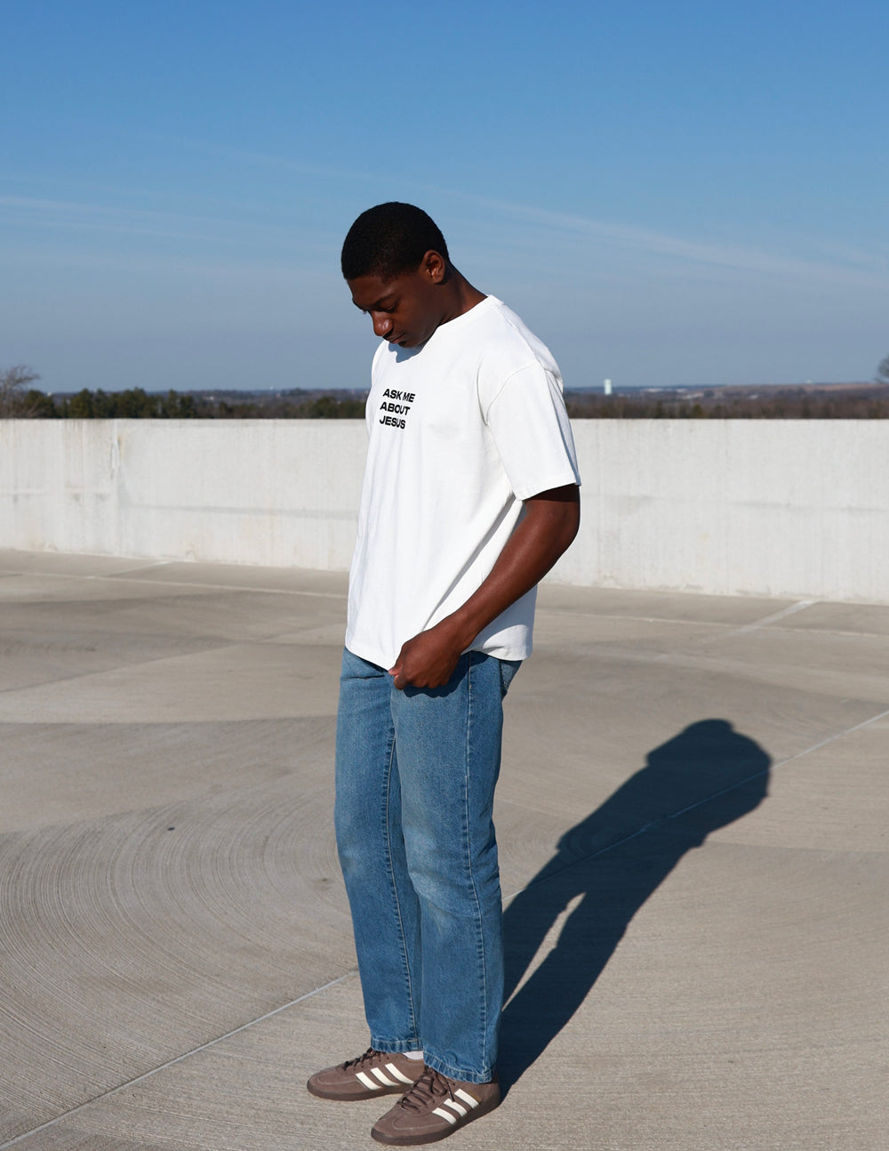 Black Elevated Faith Ask Me About Jesus heavyweight T-shirt with bold white text and comfortable fit, casual Christian apparel.