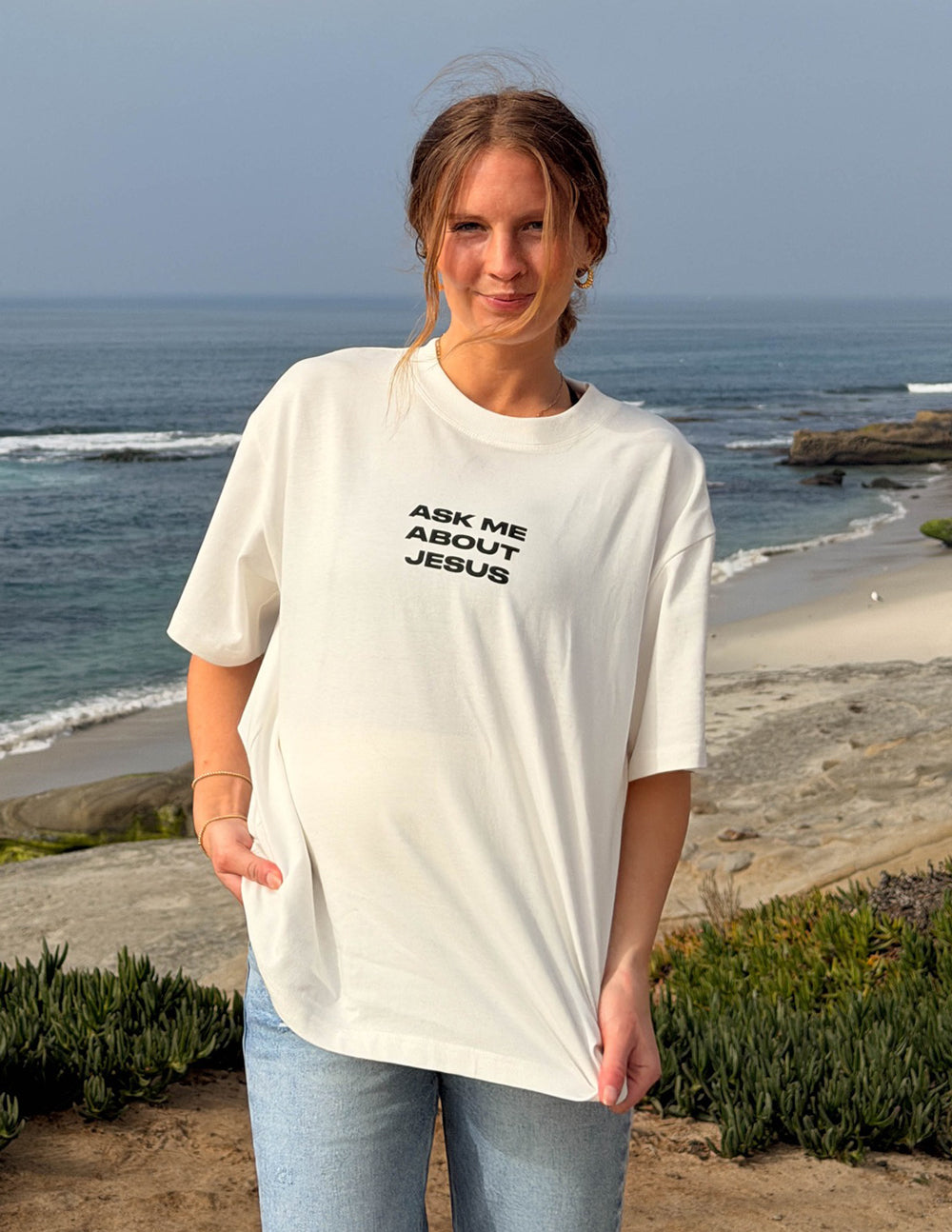 Elevated Faith Ask Me About Jesus heavyweight T-shirt with bold text, casual fit, and comfortable fabric.