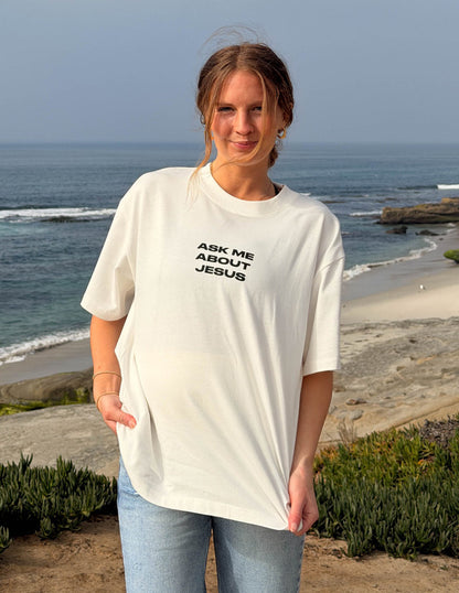 Elevated Faith Ask Me About Jesus heavyweight T-shirt with bold text, casual fit, and comfortable fabric.
